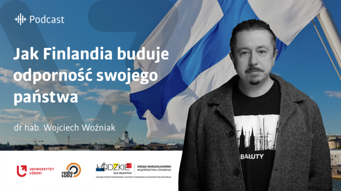 a portrait photo of Dr Wojciech Woźniak with a waving Finnish flag in the background