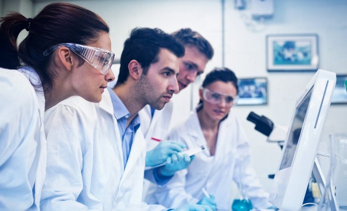 Serious researchers looking at computer screen in the lab a decorative element