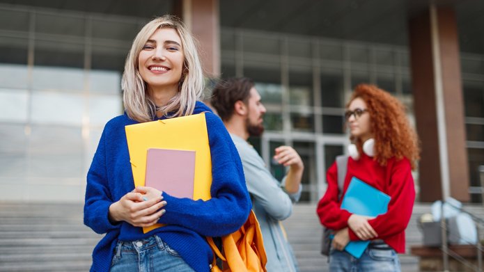 Cheerful young woman applying to university a decorative element