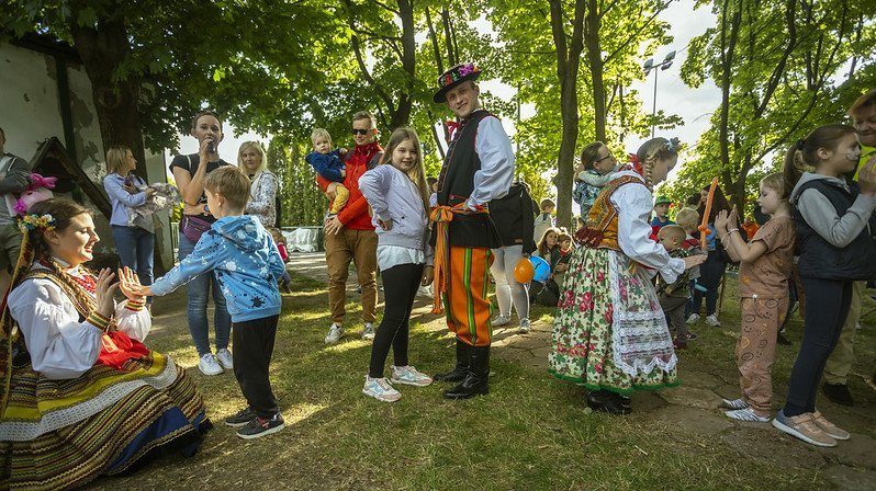 Children playing with the dancers from the Academic Folk Song and Dance Ensemble "Kujon" dressed in folk costumes
