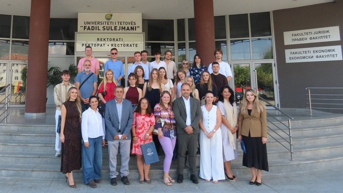 Students and academics in front of the university